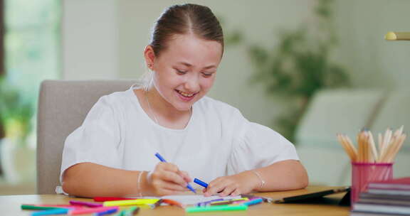 特写镜头专注于微笑的青少年女孩在书桌上用蓝色毛毡笔在白纸笔上画画