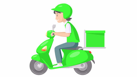 穿着绿色制服的送货箱骑着滑板车的送货男孩