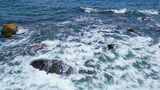 海南三亚蜈支洲岛海岸线上的礁石白沙滩海浪高清在线视频素材下载