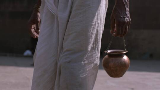 印度男人手提铜锅视频素材模板下载