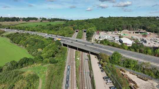 英国鸟瞰高速公路下的通勤列车超速行驶