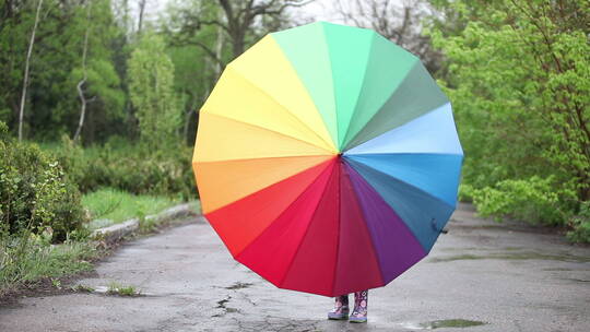 躲在雨伞后的小女孩