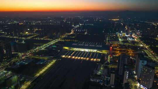 城市忙碌的高铁站黄昏夜景高铁穿梭航拍延时