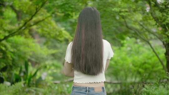 大学生美女看书学习漫步户外公园树林