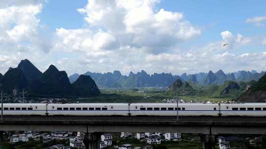 航拍山谷隧道中驶出的高铁列车