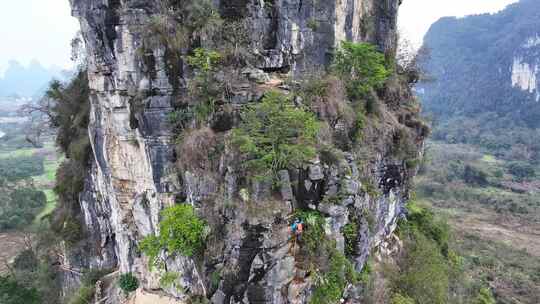 航拍攀登桂林阳朔矮山的攀岩者