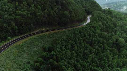 航拍豪车名车跑车汽车行驶在森林公路上山路视频素材模板下载
