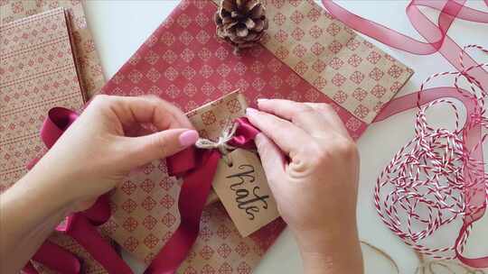 女人在礼品包装礼物上贴上礼品标签