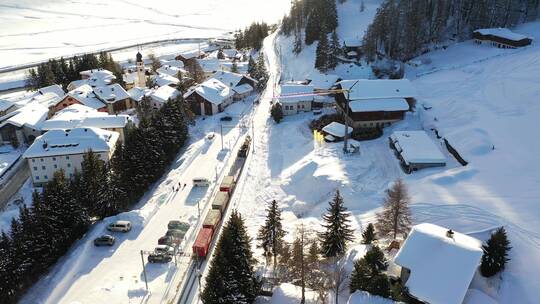 坐在火车上 穿过积雪覆盖的 森林旅行