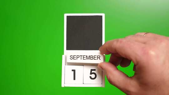 09.绿色背景上日期为9月15日的日历。