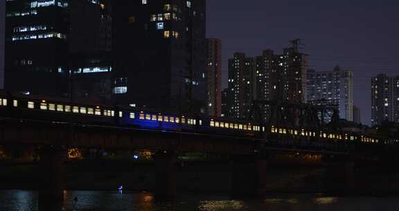 绿皮火车夜晚开进城市河流桥梁01