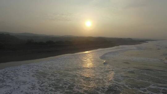 日落时海浪涌向海岸