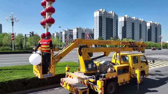 工人操作高空作业车安装灯笼