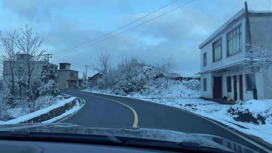 雪中乡村小路及路边房屋景象