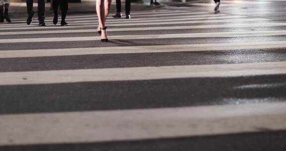 女性穿着高跟鞋在城市人行道上行走