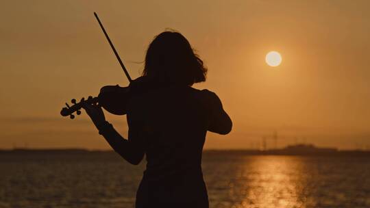 夕阳下的小提琴表演艺术家