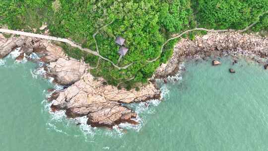 海岸边绿意盎然的山景与平静海面