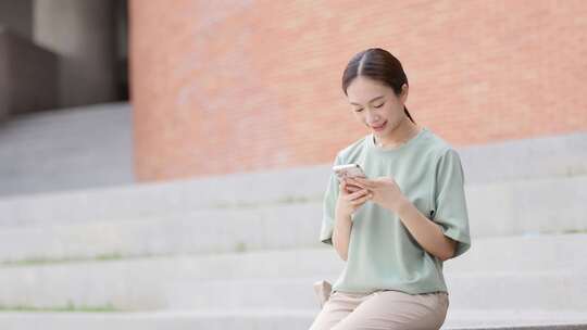 日本女人在大学里坐着打电话