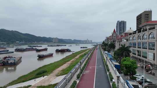 航拍广西梧州城市沿江绿道休闲观光桥西江