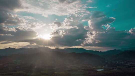 航拍广西延时日落黄昏群山绵延炊烟袅袅云密