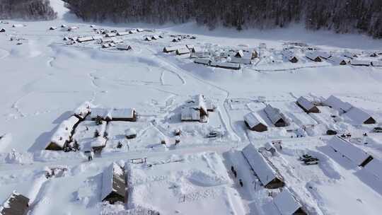 航拍新疆禾木雪景森林雪地小木屋禾木桥雪山