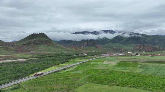 航拍青海玉树旅游藏区山间草原公路