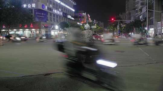 街道夜景：人来车往的县城十字路口