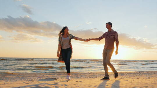 日落沙滩上散步的夫妻