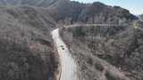 航拍山间蜿蜒公路高清在线视频素材下载