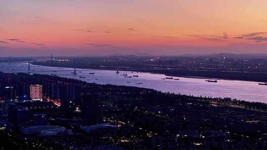 航拍长江落日夕阳南京江心洲轮船航运夜景