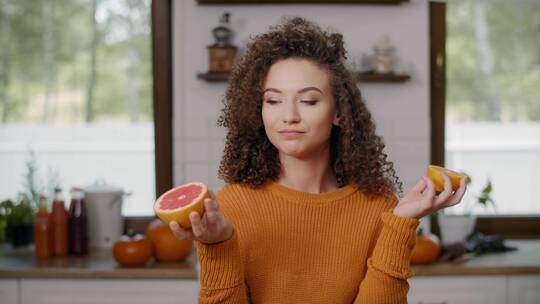 女人将柑橘类水果用作滑稽的眼睛视频素材模板下载