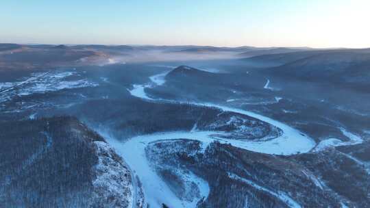 鸟瞰黎明时的林海雪原冰封河流