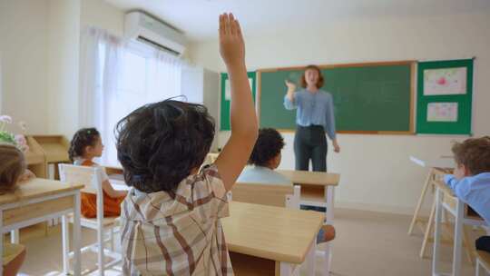 高加索年轻女子教师在学校教室教学生。