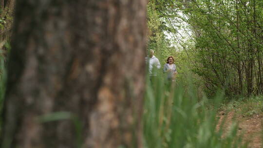 森林沿着小径慢跑的老年夫妇