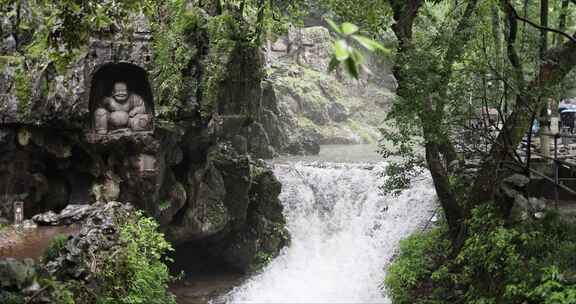 （慢镜）中国杭州灵隐寺下雨天石壁上的佛像