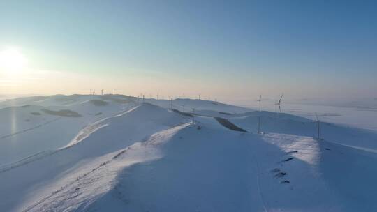 航拍内蒙古雪原山岭风力发电场