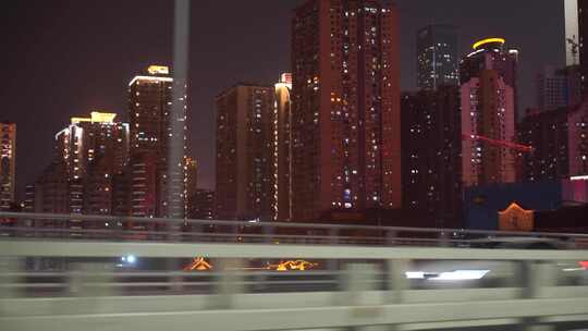 城市夜晚车窗外城市风景汽车行驶移动的建筑