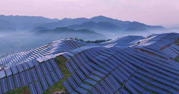 新能源太阳能光伏发电站夕阳下青山航拍
