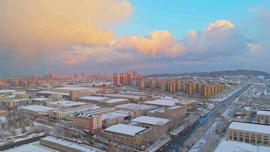 冬季航拍烟台大雪后的城市建筑和晚霞风景