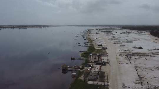 一架无人驾驶飞机沿着达喀尔粉色湖岸移动，显示了盐堆和船