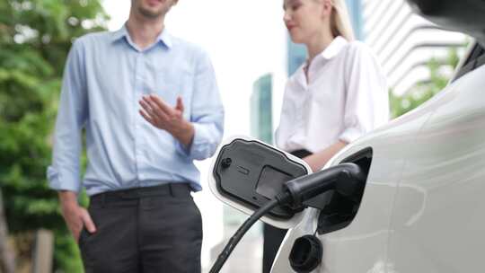 一男一女电动汽车充电站前聊天视频素材模板下载