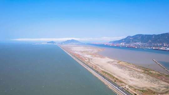 航拍大海沙滩岸边的跨海公路海边风景