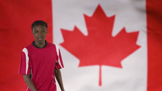 足球运动员在加拿大国旗欢呼