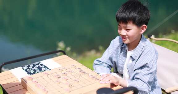 在湖边下棋的中国男孩 升格慢镜