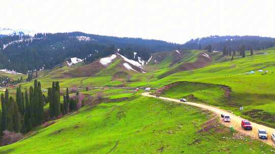 航拍新疆伊犁恰西画卷瀑布四月雪山草原