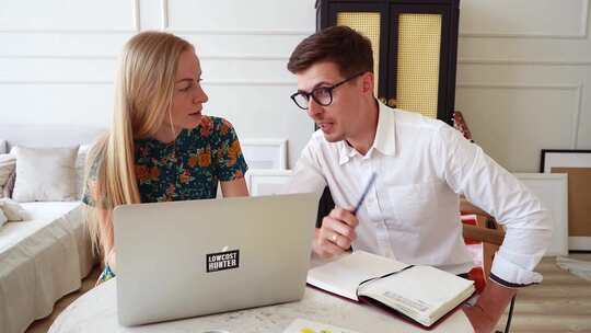 夫妇一边看着笔记本电脑一边互相交谈