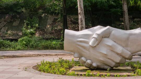清晨雨后公园握手雕塑