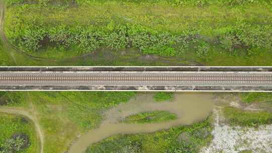 下降的航拍镜头揭示了高架铁路、绿草和棕色