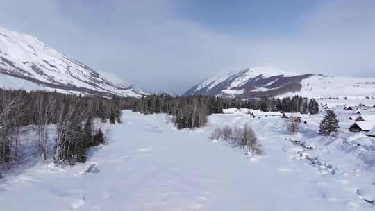 航拍新疆禾木雪景森林雪地小木屋禾木桥雪山