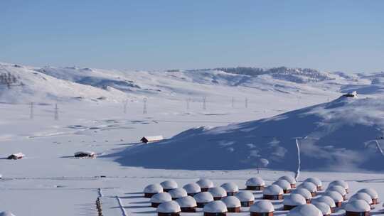 航拍新疆阿勒泰吉木乃草原石城雪景输电线路